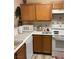 The kitchen features wooden cabinets, white countertops, and appliances at 1800 Edmond St # 213, Las Vegas, NV 89146