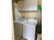Bright laundry room with washer, dryer, and upper cabinets for storage at 1800 Edmond St # 213, Las Vegas, NV 89146