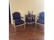 A comfortable living room featuring hardwood floors and two armchairs with a round end table at 1800 Edmond St # 213, Las Vegas, NV 89146