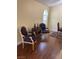 A comfortable living room featuring hardwood floors and two armchairs with a round end table at 1800 Edmond St # 213, Las Vegas, NV 89146