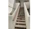 Carpeted outdoor staircase leading to upper-level units, with decorative post accents and a sturdy handrail at 1800 Edmond St # 213, Las Vegas, NV 89146
