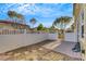 Backyard featuring white fencing, gravel, and a small paved patio area at 2020 Self Portrait St, Henderson, NV 89044