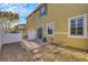 Home's backyard features a sliding glass door, a small patio, and gravel landscaping at 2020 Self Portrait St, Henderson, NV 89044