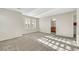 Large carpeted bedroom with multiple windows, en-suite bath, and closet at 2020 Self Portrait St, Henderson, NV 89044