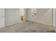 A well-lit bedroom featuring neutral walls, plush carpeting, and a shuttered window with a bathroom nearby at 2020 Self Portrait St, Henderson, NV 89044