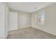 A well-lit bedroom with neutral walls, plush carpeting, and a shuttered window for adjustable natural light at 2020 Self Portrait St, Henderson, NV 89044