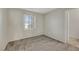 A well-lit bedroom featuring neutral walls, plush carpeting, and a shuttered window for adjustable natural light at 2020 Self Portrait St, Henderson, NV 89044