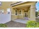Exterior shot of a covered porch area, gravel landscaping, and white fence at 2020 Self Portrait St, Henderson, NV 89044
