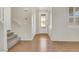 Bright entryway with hardwood floors, decorative front door, staircase, and fresh paint at 2020 Self Portrait St, Henderson, NV 89044
