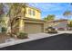 Two-story home featuring a garage and desert landscaping with a neatly paved driveway at 2020 Self Portrait St, Henderson, NV 89044