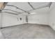 Interior of the garage showcasing the concrete floor, garage door mechanism, and water heater at 2020 Self Portrait St, Henderson, NV 89044