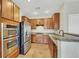Modern kitchen featuring stainless steel appliances, warm wood cabinetry, and recessed lighting at 2020 Self Portrait St, Henderson, NV 89044