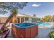 Backyard oasis features a hot tub, swimming pool and mature trees for relaxation and entertainment at 2254 Florence Ave, Las Vegas, NV 89119
