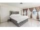 Bedroom featuring a large bed with a tufted headboard and a window with curtains at 2254 Florence Ave, Las Vegas, NV 89119