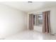 Bedroom featuring matching tile flooring, window, and curtains at 2254 Florence Ave, Las Vegas, NV 89119