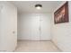 Inviting foyer featuring neutral tile flooring, white double-door entryway, and a decorative wall painting at 2254 Florence Ave, Las Vegas, NV 89119