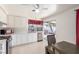 Bright kitchen featuring white cabinets, stainless steel appliances, and a dining area at 2254 Florence Ave, Las Vegas, NV 89119