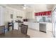 Clean kitchen with white cabinets, stainless steel appliances, and a dining area at 2254 Florence Ave, Las Vegas, NV 89119