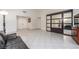 Bright living room featuring tile floors, white walls, and a mirrored storage cabinet at 2254 Florence Ave, Las Vegas, NV 89119