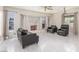 Comfortable living room with a stone fireplace and large windows at 2254 Florence Ave, Las Vegas, NV 89119