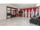 Bright living room with tile floors, large windows with drapes, and comfortable seating and mirrored wall at 2254 Florence Ave, Las Vegas, NV 89119
