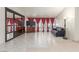 Bright living room with tile floors, large windows with drapes, and comfortable seating with a TV at 2254 Florence Ave, Las Vegas, NV 89119