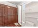 Shower with tiled walls, shower head, grab bar and window with storage at 2254 Florence Ave, Las Vegas, NV 89119