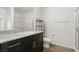 Bathroom featuring granite countertops, modern fixtures, and a glass-enclosed shower at 2677 Saddle Bronze Ct, North Las Vegas, NV 89086