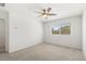 A bedroom featuring a ceiling fan, white walls, carpet flooring, and a window at 2677 Saddle Bronze Ct, North Las Vegas, NV 89086