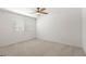 An empty bedroom featuring a ceiling fan, carpet flooring, and a window at 2677 Saddle Bronze Ct, North Las Vegas, NV 89086