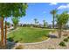 A community park with manicured lawns, mature trees, and landscaping on a sunny day at 2677 Saddle Bronze Ct, North Las Vegas, NV 89086