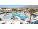 Modern community pool area features unique water features, sun umbrellas and lounge chairs at 2677 Saddle Bronze Ct, North Las Vegas, NV 89086