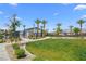 Manicured lawns, mature trees and landscaping surround the community pool on a sunny day at 2677 Saddle Bronze Ct, North Las Vegas, NV 89086