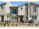 Two-story townhome featuring a small front yard, balcony, neutral color scheme, and a welcoming entrance at 2677 Saddle Bronze Ct, North Las Vegas, NV 89086
