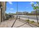 A townhome's entry featuring a stone-paved patio with a black metal fence at 2677 Saddle Bronze Ct, North Las Vegas, NV 89086
