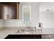 The kitchen features stainless steel sink, granite countertops, and modern faucet at 2677 Saddle Bronze Ct, North Las Vegas, NV 89086