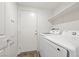 Laundry room with white washer and dryer, white door and shelving at 2677 Saddle Bronze Ct, North Las Vegas, NV 89086