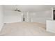 Bright, open living room with neutral carpet and ceiling fan at 2677 Saddle Bronze Ct, North Las Vegas, NV 89086
