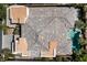 Aerial view of a home showcasing its roof and backyard with a pool, nestled among mature trees at 29 Owl Ridge Ct, Las Vegas, NV 89135