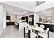 Open dining area with modern table and chairs, open to the kitchen, featuring an elegant lighting fixture at 29 Owl Ridge Ct, Las Vegas, NV 89135