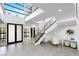 A bright and modern home entryway featuring large windows and a sleek staircase at 29 Owl Ridge Ct, Las Vegas, NV 89135