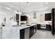 Open concept kitchen showcasing a marble island, stainless steel appliances, and modern fixtures at 29 Owl Ridge Ct, Las Vegas, NV 89135