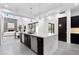 Modern kitchen boasts a large marble island, stainless steel appliances, and an open concept design leading into the living area at 29 Owl Ridge Ct, Las Vegas, NV 89135