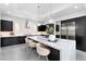 Bright kitchen featuring a large island with seating, modern pendant lighting, stainless steel appliances, and custom backsplash at 29 Owl Ridge Ct, Las Vegas, NV 89135