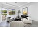 Stylish living room with modern furnishings, contemporary art, and natural light from large windows at 29 Owl Ridge Ct, Las Vegas, NV 89135