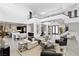 Bright open living room with soaring ceilings, modern decor, and access to the kitchen at 29 Owl Ridge Ct, Las Vegas, NV 89135