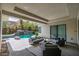 Inviting outdoor living space with comfortable patio seating, a pool, and lush landscaping, perfect for relaxation at 29 Owl Ridge Ct, Las Vegas, NV 89135