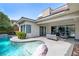 Lovely backyard patio with a pool and spa, featuring a modern outdoor seating area and seamless indoor-outdoor living at 29 Owl Ridge Ct, Las Vegas, NV 89135