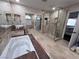 Luxurious bathroom with a soaking tub, glass-enclosed shower, and tiled finishes at 2913 Domino Way, Las Vegas, NV 89117