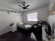 Functional bedroom featuring wood floors, a ceiling fan, a window and a recliner at 2913 Domino Way, Las Vegas, NV 89117